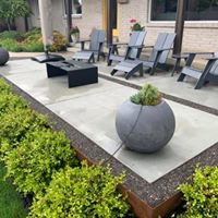 FORMAL CONCRETE PATIO Concrete patio with patio chairs and small black table
