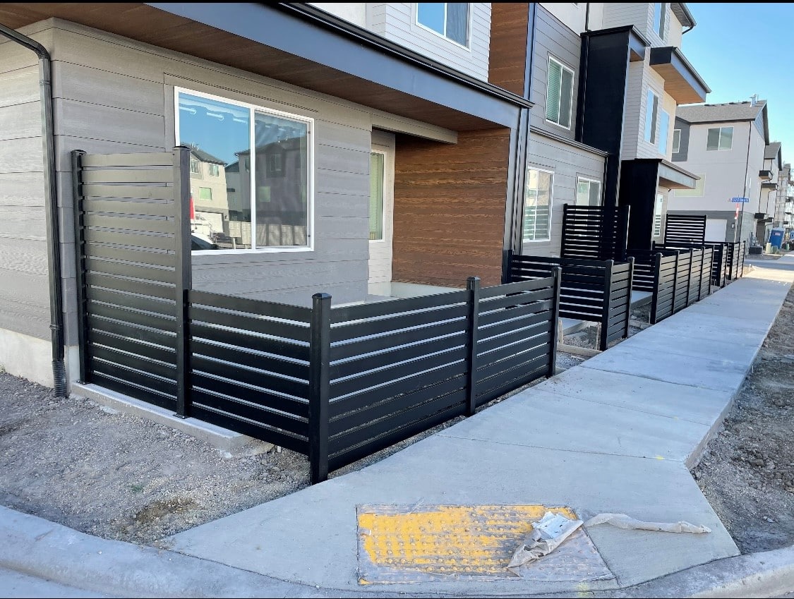 AV 2 Small black fence out front of someone's home.