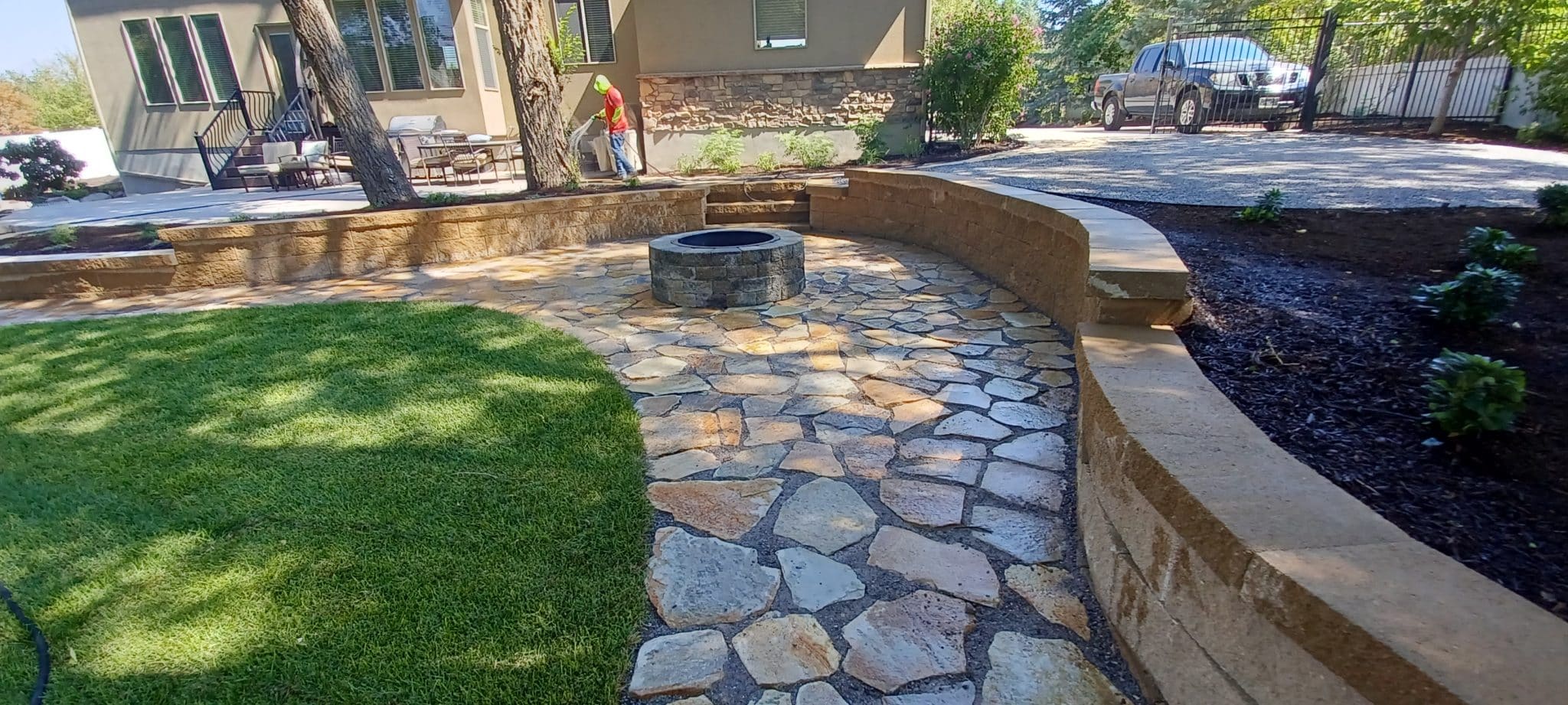 BLOCK RETAINING WALL Walkway leading to an outdoor fireplace