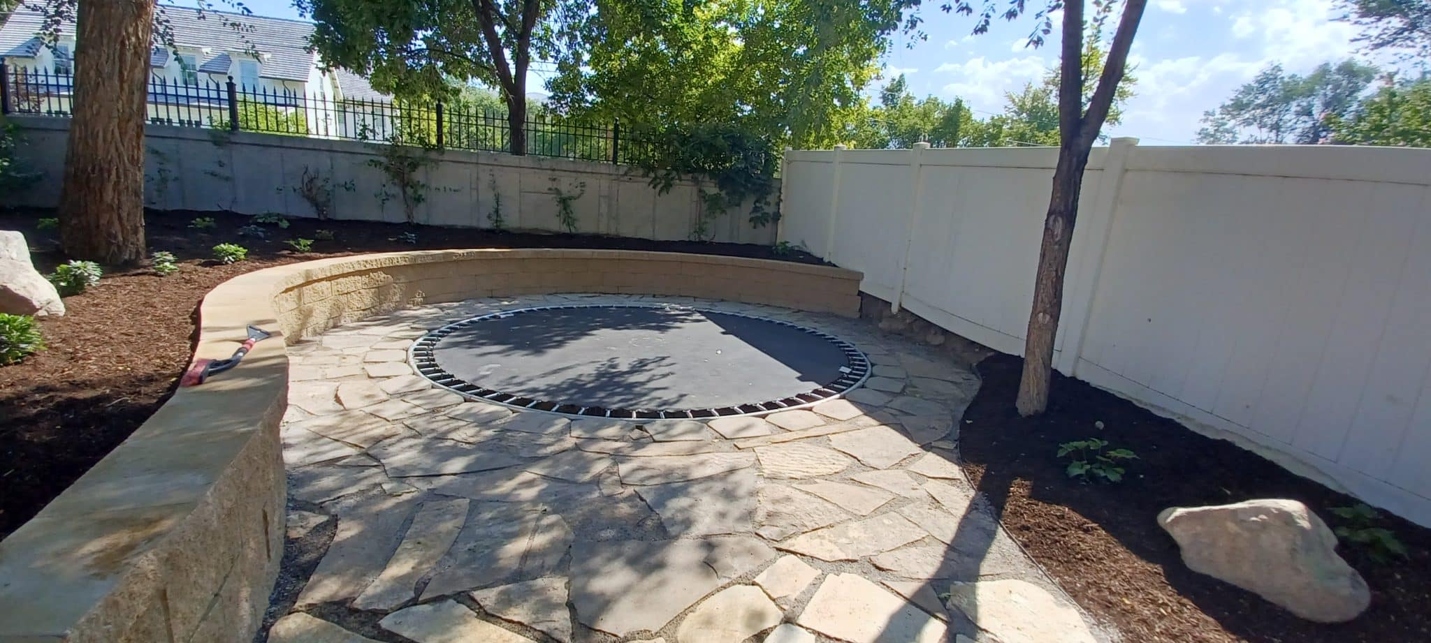 BLOCK RETAINING WALL AFTER floor level trampoline in front of retaining wall