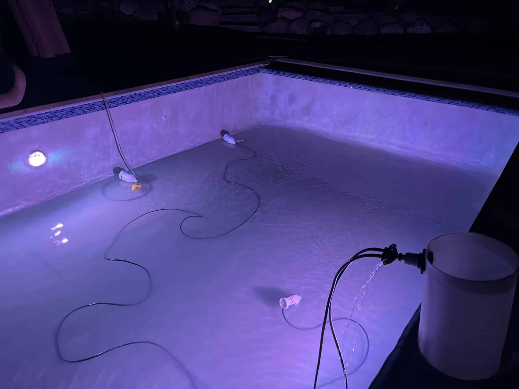 71833636177–5C795D57-1A37-4945-9B57-A3F874FF9B9C Swimming pool with purple lighting after dark.