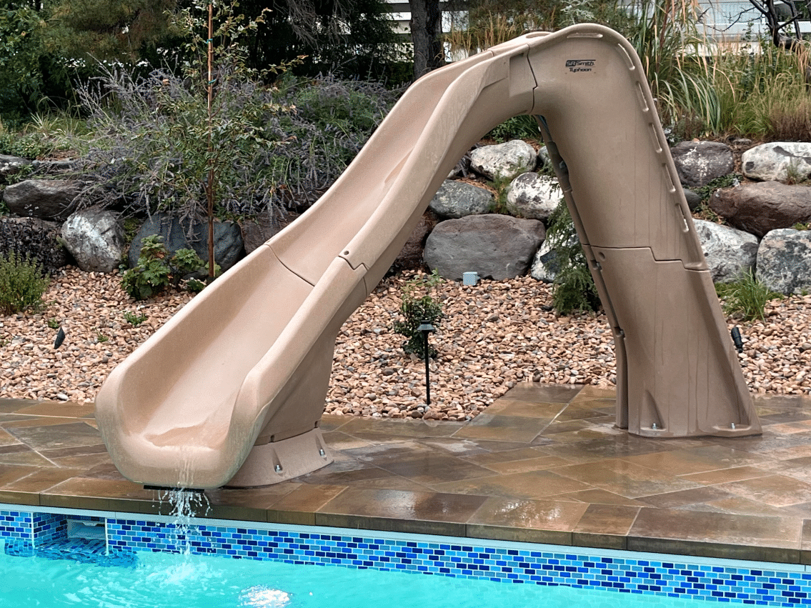 Screen Shot 2023-10-12 at 4.22.30 PM A custom slide leading to a swimming pool