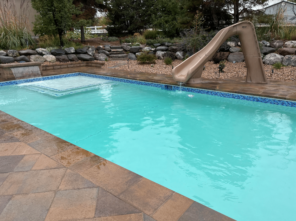 Screen Shot 2023-10-12 at 4.22.39 PM Swimming pool with water slide leading to the water