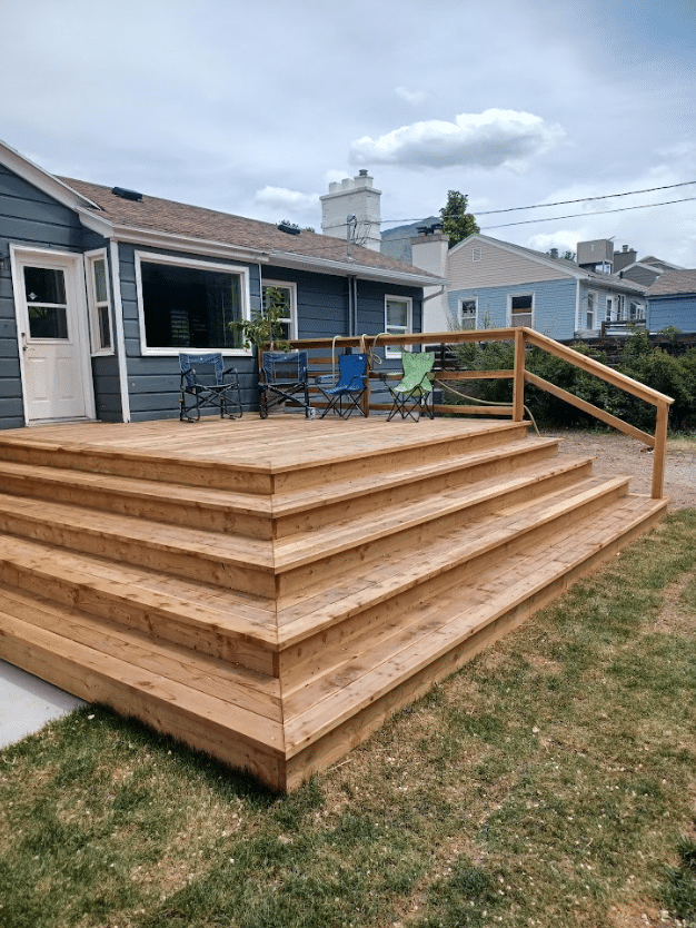 Screen Shot 2024-09-18 at 12.35.02 PM Wooden brown deck in a back yard.