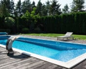 Inground swimming pool with pool deck and seating