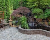 Patio and waterfall feature in the backyard of a home