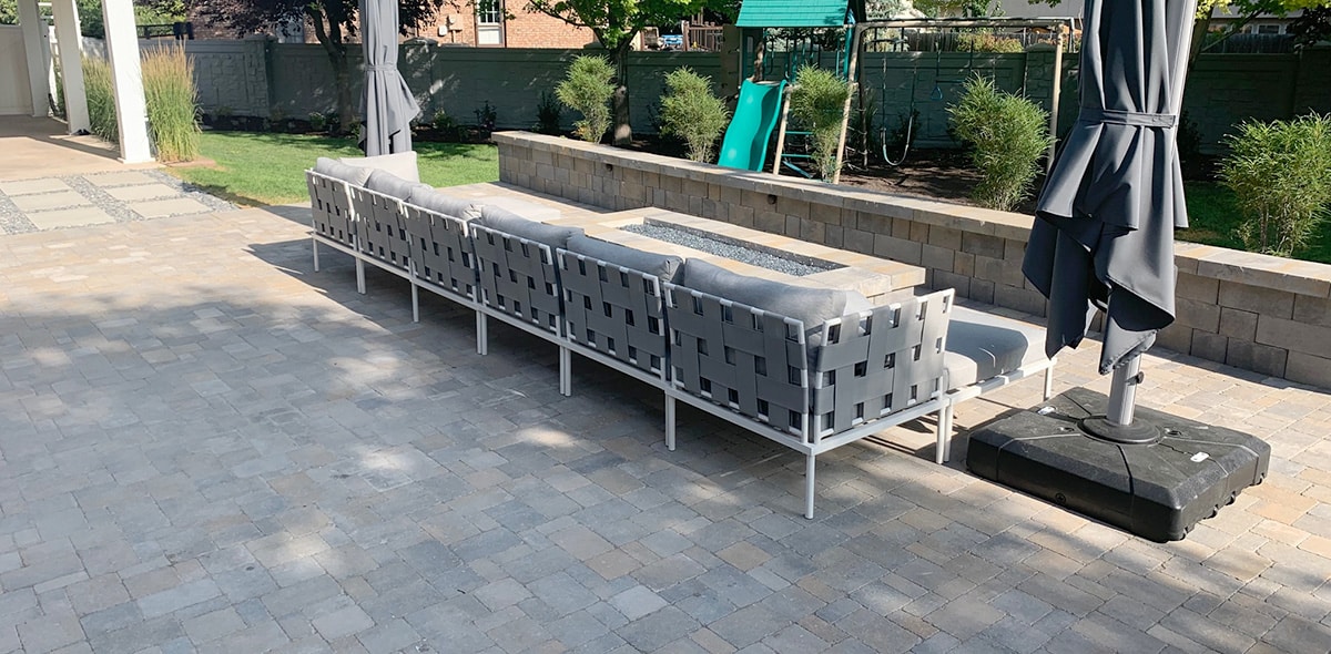 Patio with firepit seating and stone wall