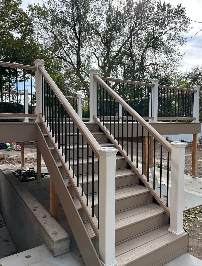 Screenshot_20251013_173535_Gallery Custom deck with stairs leading up to deck.