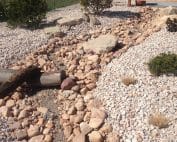 Xeriscape with gravel, dry river bed and native Utah plants
